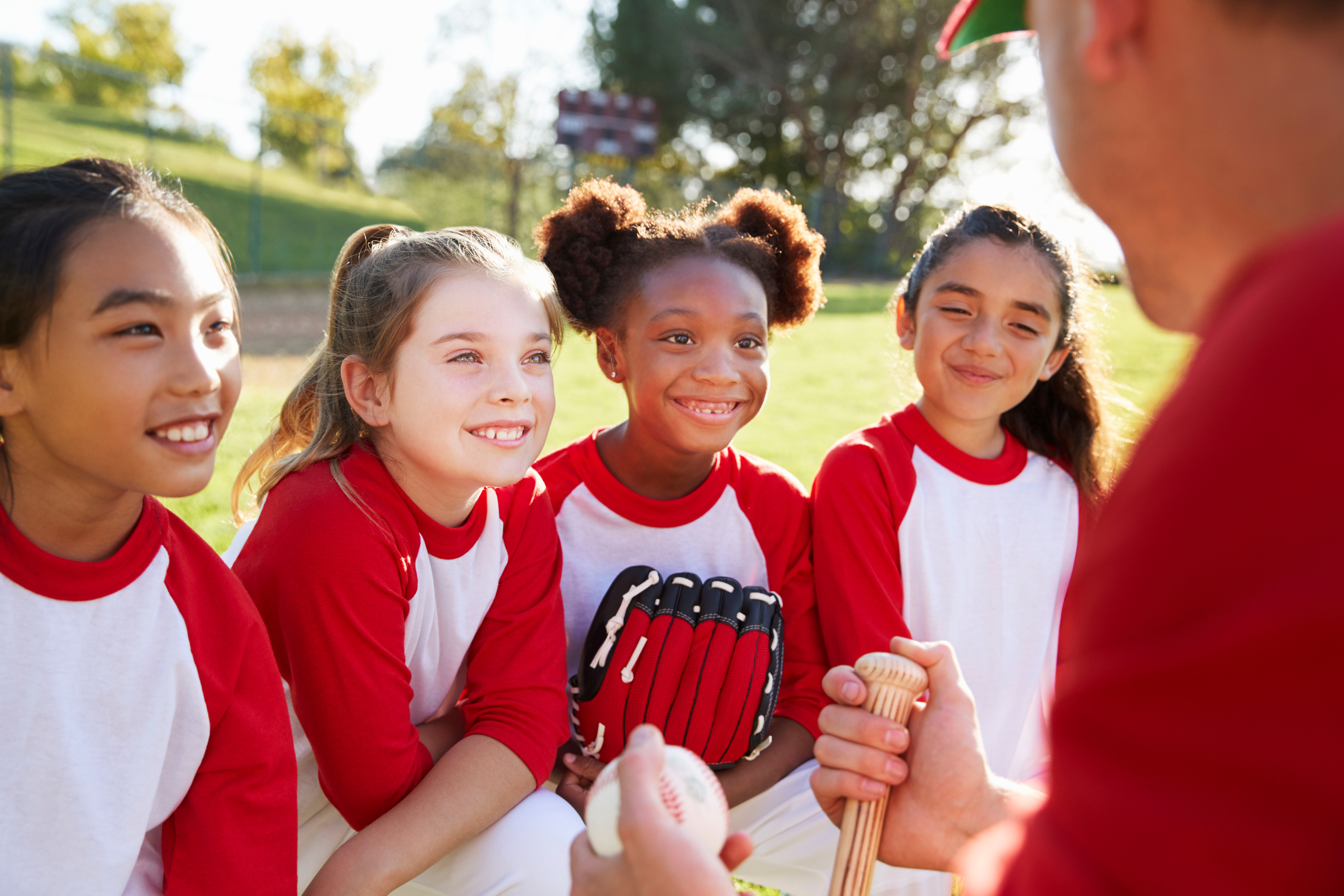 Girl Baseball Team in a Team Huddle